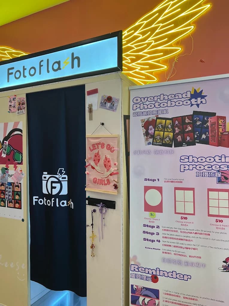 Closer view of the photobooth curtain and overhead photobooth how-to poster at imizzu